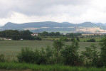 Krajina Poohří od vyhlídky na dálnici D8 – vpravo cementárna Čížkovice, v pozadí České středohoří. Foto M. Říha